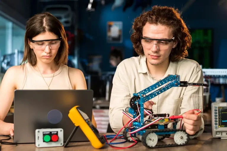 Two people examining a robotics kit for a technology update article.